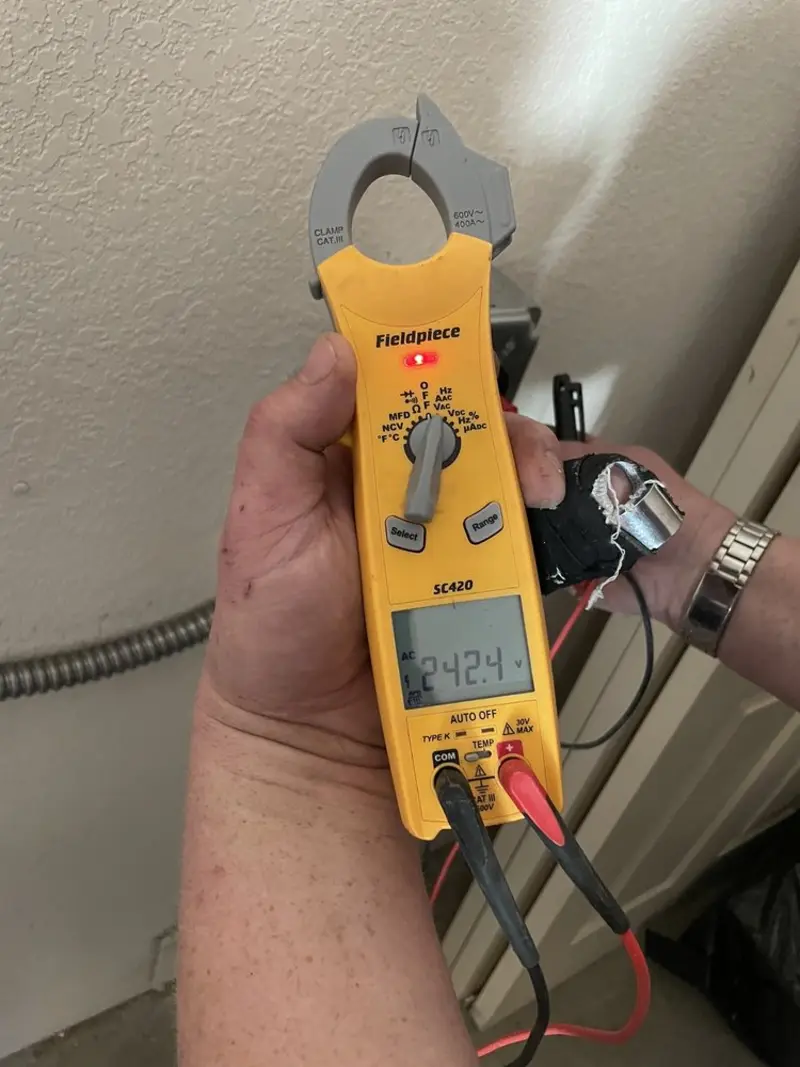Voltage testing with clamp meter during Recessed Lighting Installation in West Manchester